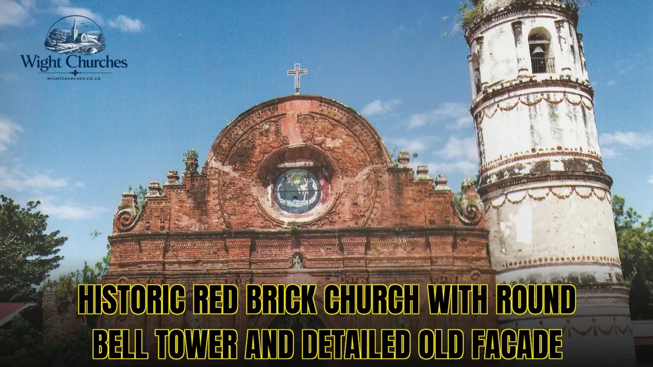 Historic red brick church with round bell tower and detailed old facade