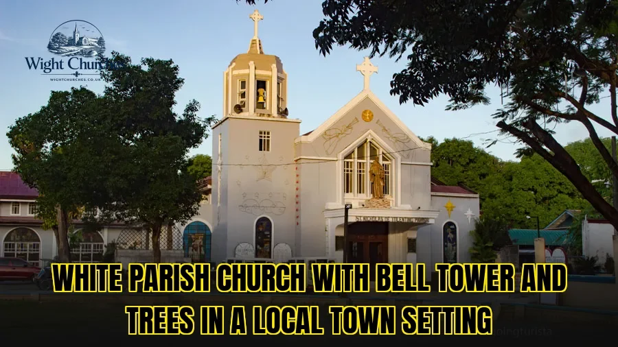 White parish church with bell tower and trees in a local town setting